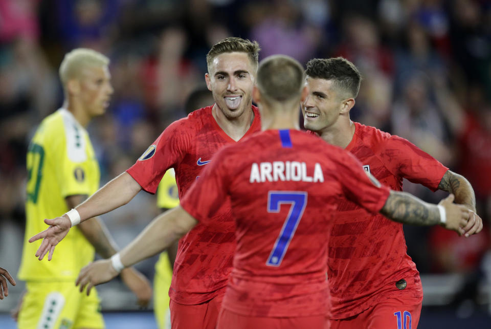 United States' Tyler Boyd, facing camera, celebrates with teammates Paul Arriola (7) and Christian Pulisic (10) as Guyana's Matthew Briggs (20) walks away during the second half of a CONCACAF Gold Cup soccer match Tuesday, June 18, 2019, in St. Paul, Minn. (AP Photo/Andy Clayton-King)