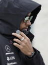 Mercedes driver Lewis Hamilton, of Britain, walks to a news conference for the Formula One U.S. Grand Prix auto race at the Circuit of the Americas, Thursday, Oct. 18, 2018, in Austin, Texas. (AP Photo/Darren Abate)