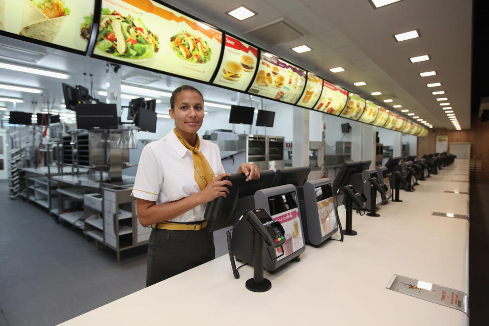 LONDON, ENGLAND - JUNE 25: Assistant manager Rachel Lucien stands at the checkouts in the world's largest McDonald's restaurant which is their flagship outlet in the Olympic Park on June 25, 2012 in London, England. The restaurant, which is one of four McDonald's to be situated within the Olympic Park, will have a staff of 500. After the Olympic and Paralympic Games conclude the restaurant will be dismantled and all fixtures and fittings will be either reused or recycled. (Photo by Oli Scarff/Getty Images)