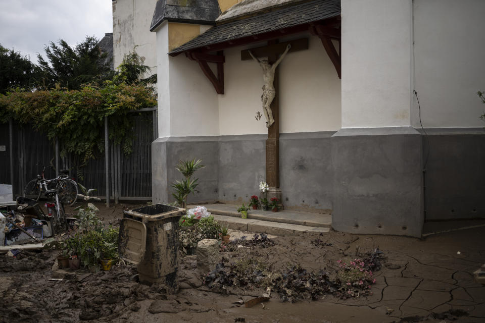 A crucifix in the town of Bad Neuenahr-Ahrweiler, Germany, Monday July 19, 2021. More than 180 people died when heavy rainfall turned tiny streams into raging torrents across parts of western Germany and Belgium, and officials put the death toll in Ahrweiler county alone at 110. (AP Photo/Bram Janssen)