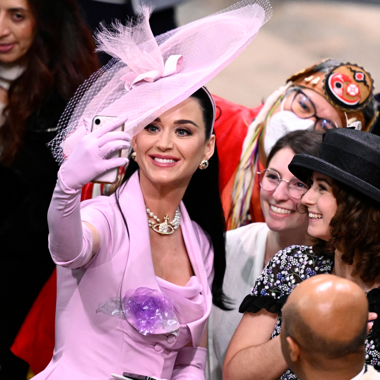  Katy Perry takes selfies with guests during the Coronation of King Charles III and Queen Camilla on May 06, 2023 in London, England. The Coronation of Charles III and his wife, Camilla, as King and Queen of the United Kingdom of Great Britain and Northern Ireland, and the other Commonwealth realms takes place at Westminster Abbey today. Charles acceded to the throne on 8 September 2022, upon the death of his mother, Elizabeth II. 