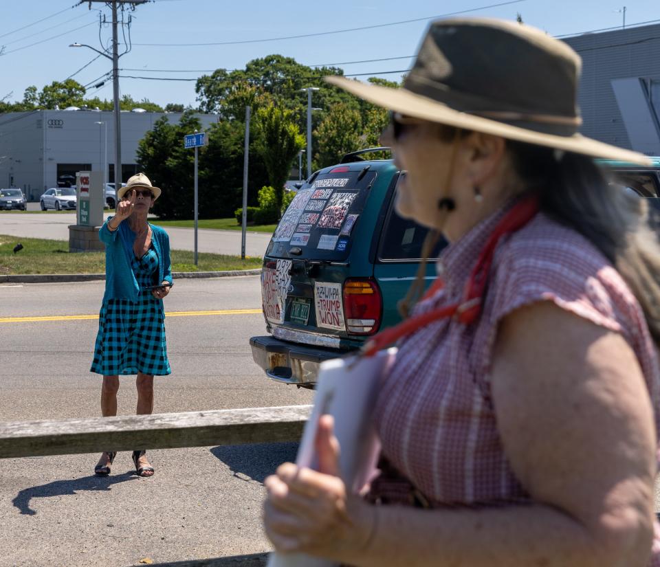 Lisa Davis, 61, walks away from a woman who is arguing with people protesting at the Hyannis rotary on Saturday about the Supreme Court's decision to overturn Roe v. Wade, the 1973 decision legalizing abortion.