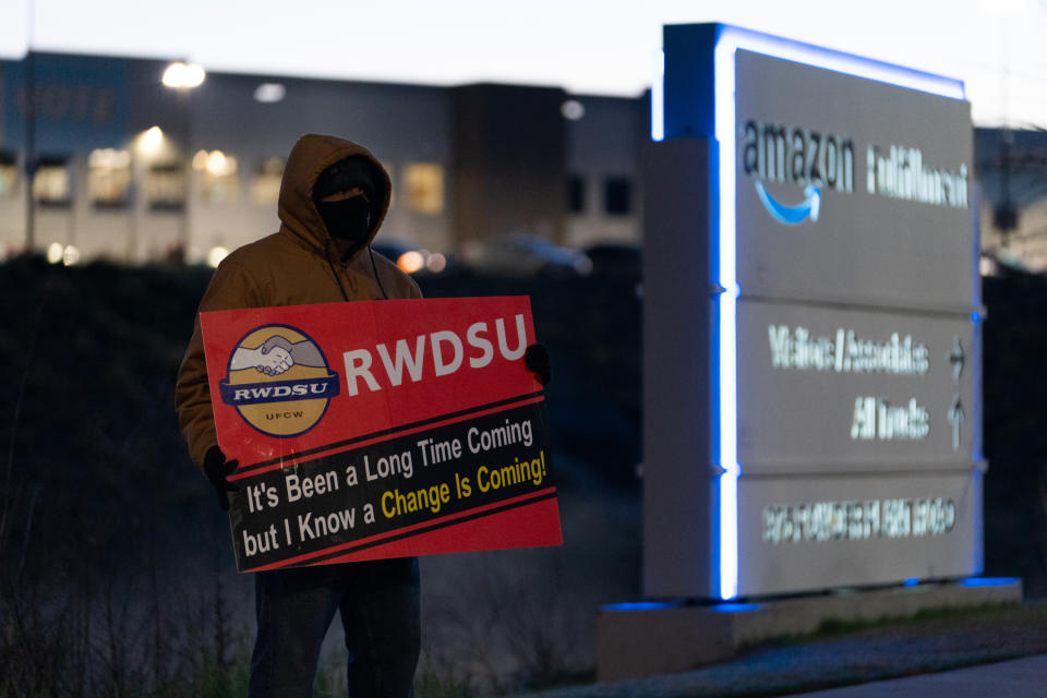 BESSEMER, AL - MARCH 29: An RWDSU union rep holds a sign outside the Amazon fulfillment warehouse at the center of a unionization drive on March 29, 2021 in Bessemer, Alabama. Employees at the fulfillment center are currently voting on whether to form a union, a decision that could have national repercussions. (Photo by Elijah Nouvelage/Getty Images)