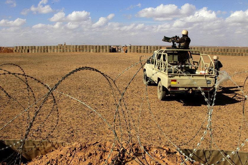 In this picture taken Tuesday, Feb. 14, 2017, a Jordanian soldier stands at the north eastern border with Syria, close to the informal Rukban camp. The commander of Jordan's border guards says Islamic State extremists are expanding their influence in the sprawling border camp for tens of thousands of displaced Syrians, posing a growing threat to the U.S.-allied kingdom. (AP Photo/ Raad Adayleh)