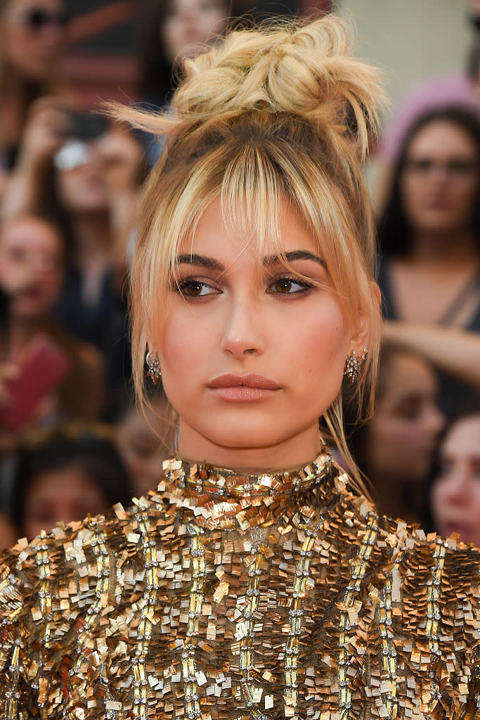 <p>The 19-year-old stunner went for an earthy look with neutral lips and a bronze eye. To make sure her hair didn’t hide any of her sequined gold minidress, she kept it up in a loose top knot – which was also perfect for the hot Toronto weather. <i>(Photo by George Pimentel/WireImage)</i></p>