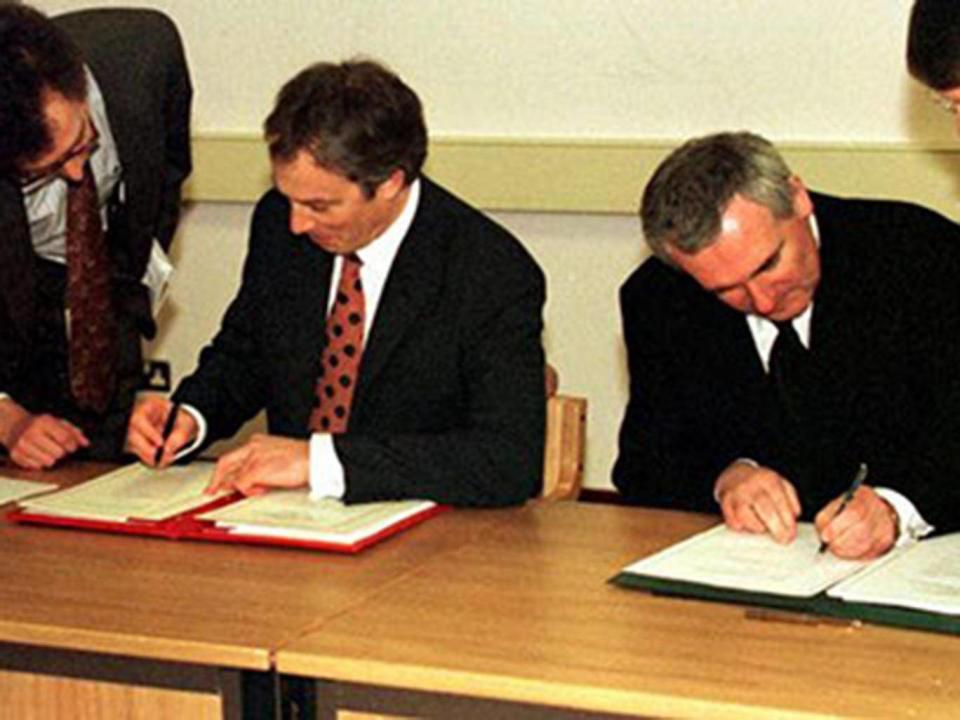 Tony Blair and the Irish taoiseach Bertie Ahern sign the Good Friday Agreement in 1998 (PA)