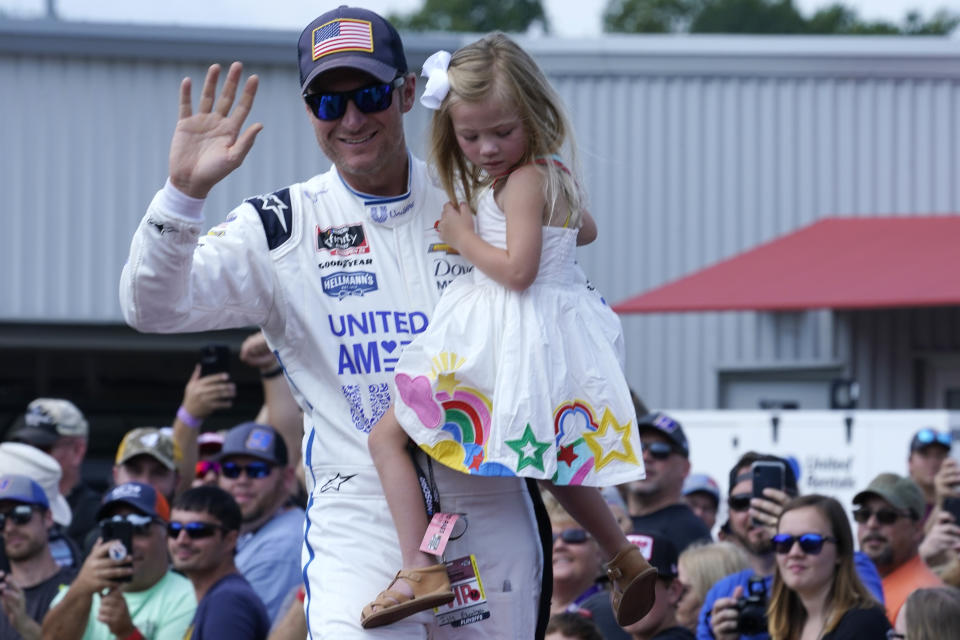 Dale Earnhardt Jr., holds his daughter Isla, 3, during driver introductions before the NASCAR Xfinity auto race in Richmond, Va., Saturday, Sept. 11, 2021. (AP Photo/Steve Helber)