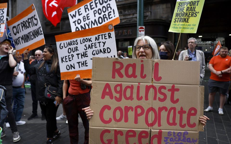 Rail workers on a picket line outside Glasgow Central station in the summer - Jeff J Mitchell/Getty Images