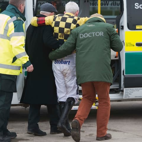 Ruby Walsh is taken to hospital with a suspected broken right leg - Credit: Eddie Mulholland for The Telegraph