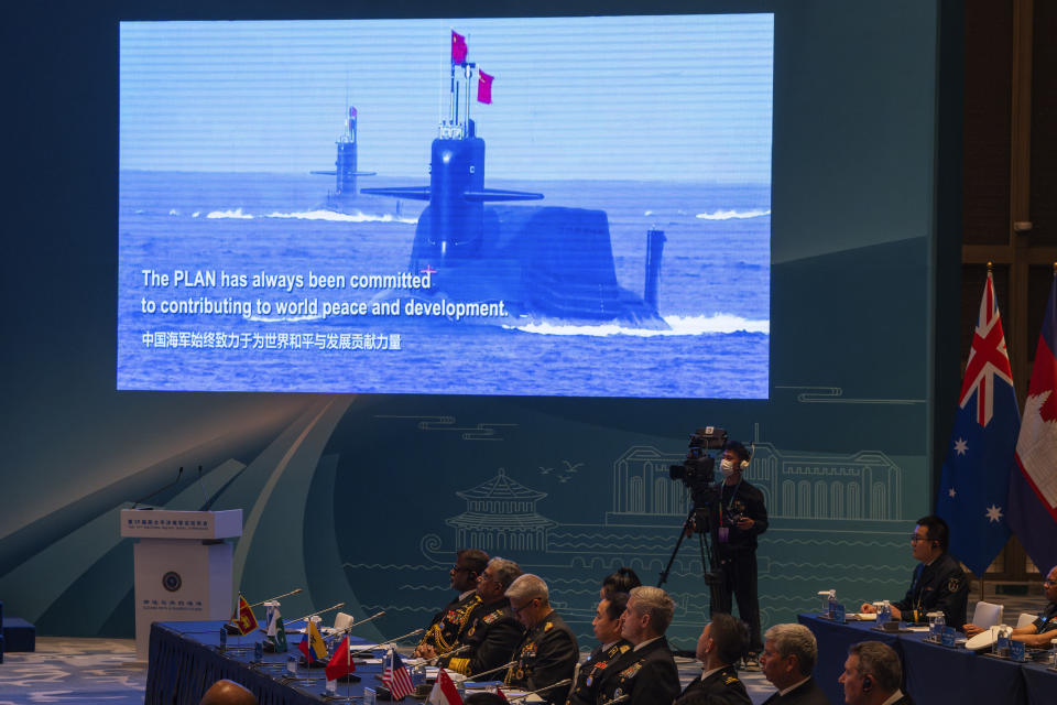 A screen shows Chinese submarines at the opening of the Western Pacific Navy Symposium in Qingdao, eastern China's Shandong province on Monday, April 22, 2024. Zhang Youxia, one of China's top military leaders took a harsh line on regional territorial disputes, telling an international naval gathering in northeastern China on Monday that the country would strike back with force if its interests came under threat. (AP Photo/Ng Han Guan)