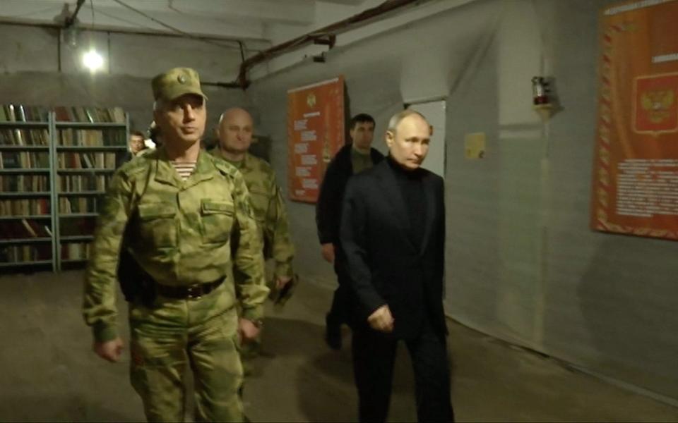 Russian President Vladimir Putin visiting Russian national guard headquarters in the Lugansk region in the east of Ukraine, which is partly controlled by Russian troops. - AFP