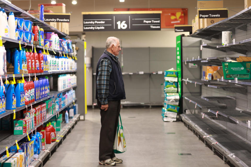 A senior stares at empty shelves at Woolworths. (Photo by Chu Chen/Xinhua via Getty)