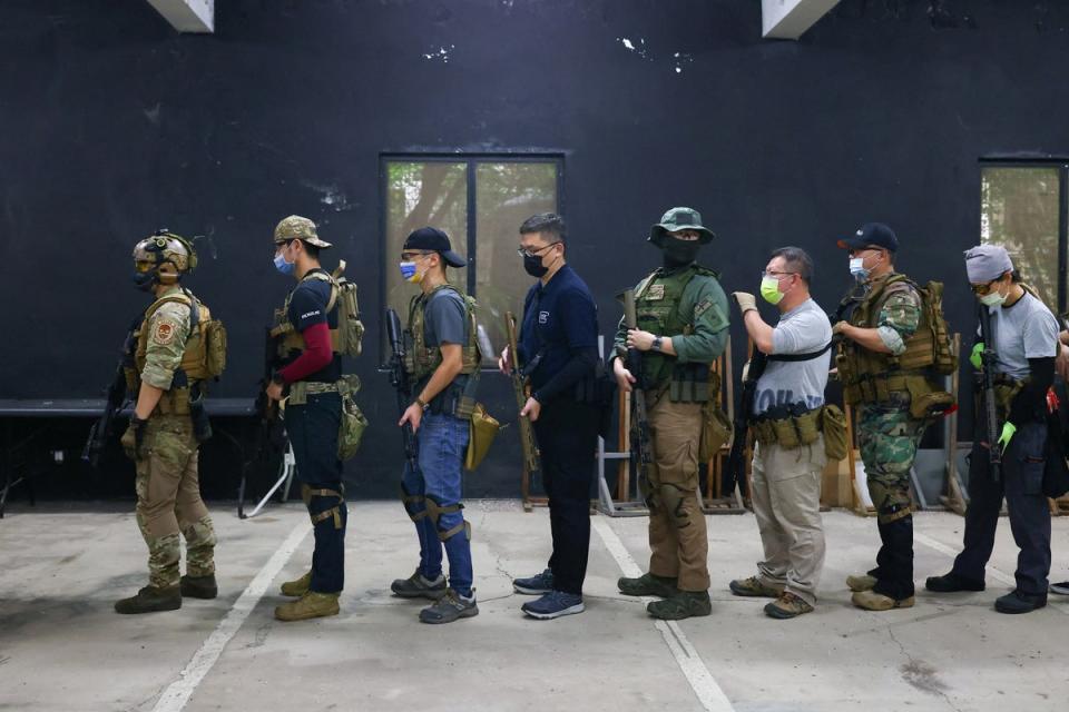 Trainees line up to practise target shooting (Reuters)