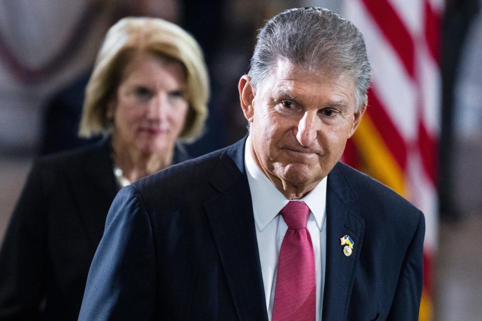 Sen. Joe Manchin, D-W.Va., and Sen. Shelley Moore Capito, R-W.Va., pay their respects as the flag-draped casket bearing the remains of Hershel W. "Woody" Williams, lies in honor in the U.S. Capitol on July 14 in Washington. Manchin has told Senate Majority Leader Chuck Schumer that he will oppose an economic measure if it includes climate or energy provisions or boosts taxes on the rich or corporations.