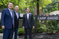 FILE - U.S. President Joe Biden, center, greets South Korea's President Yoon Suk Yeol, left, and Japan's Prime Minister Fumio Kishida, right, on Aug. 18, 2023, at Camp David, the presidential retreat, near Thurmont, Md. South Korea’s President Yoon said the international community “will unite more tightly” to cope with deepening military cooperation between Russia and North Korea, as he pushes to raise the issue with world leaders at the U.N. General Assembly this week.(AP Photo/Andrew Harnik, File)