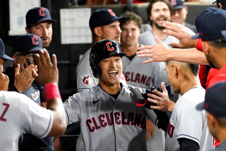 Cleveland Guardians’ Steven Kwan is congratulated in the dugout after his home run off Chicago White Sox starting pitcher Lance Lynn during the fourth inning of a baseball game Wednesday, Sept. 21, 2022, in Chicago. (AP Photo/Charles Rex Arbogast)