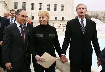 Pamela (C) and Douglas Hurst (R), both plaintiffs in King v. Burwell, await speak to reporters in front of the Supreme Court in Washington March 4, 2015. REUTERS/Gary Cameron