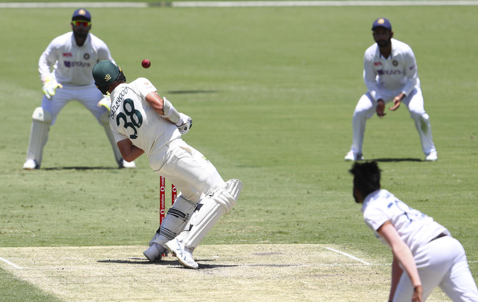 Australia's Josh Hazlewood avoids a bouncer from India's Mohammed Siraj during play on day two of the fourth cricket test between India and Australia at the Gabba, Brisbane, Australia, Saturday, Jan. 16, 2021. (AP Photo/Tertius Pickard)