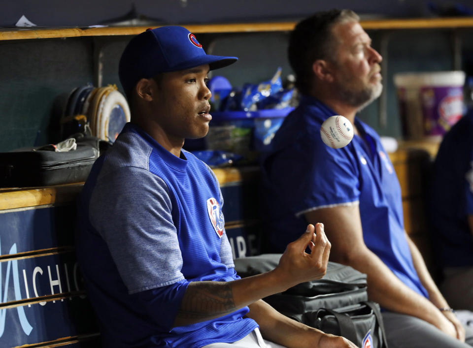 FILE - In this Aug. 21, 2018, file photo, Chicago Cubs' Addison Russell flips a baseball in the dugout in the sixth inning of a baseball game against the Detroit Tigers in Detroit, Russell was placed on administrative leave Friday, Sept. 21, 2018, following fresh allegations of domestic violence by his ex-wife. (AP Photo/Paul Sancya, File)