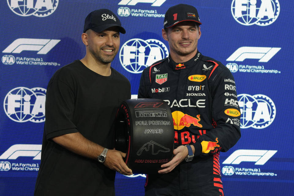 Red Bull driver Max Verstappen of the Netherlands, right, is presented pole position award after qualifying session ahead of the Abu Dhabi Formula One Grand Prix at the Yas Marina Circuit, Abu Dhabi, UAE, Saturday, Nov. 25, 2023. (AP Photo/Kamran Jebreili)