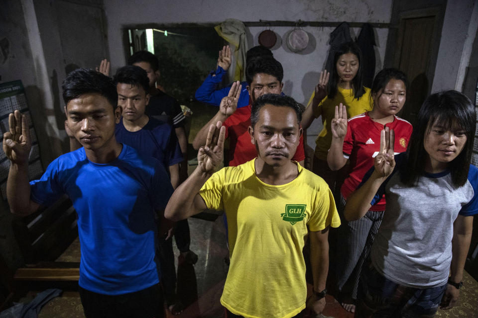 Police officers who fled Myanmar following a military coup display the three-finger salute at an undisclosed location bordering Myanmar, in the northeastern Indian state of Mizoram, Thursday, March 18, 2021. A group of Myanmar policemen raised athree-finger salute, a symbol of resistance, as they recounted their escape to India, after defying the Myanmar army orders to shoot people who opposed the Feb. 1 army coup in southeast Asian country. “We cannot hurt our people, that’s why we came to Mizoram,” said one of them, who hailed from the northwestern town of Tedim in Myanmar. (AP Photo/Anupam Nath)