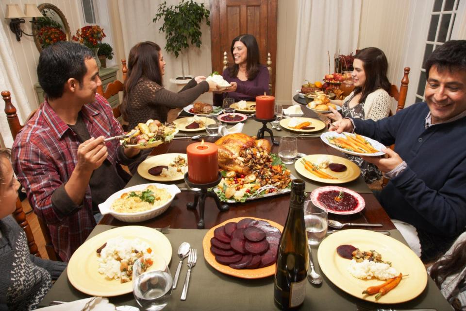 Dishes are passed around a holiday dinner table