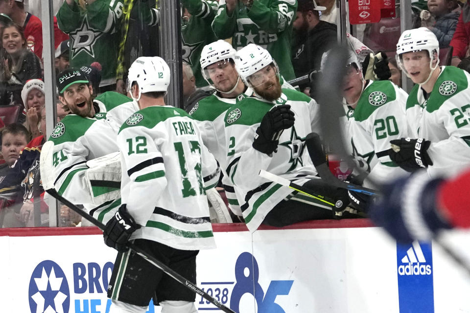 Dallas Stars center Radek Faksa (12) is congratulated after scoring a goal during the first period of an NHL hockey game against the Florida Panthers, Wednesday, Dec. 6, 2023, in Sunrise, Fla. (AP Photo/Lynne Sladky)