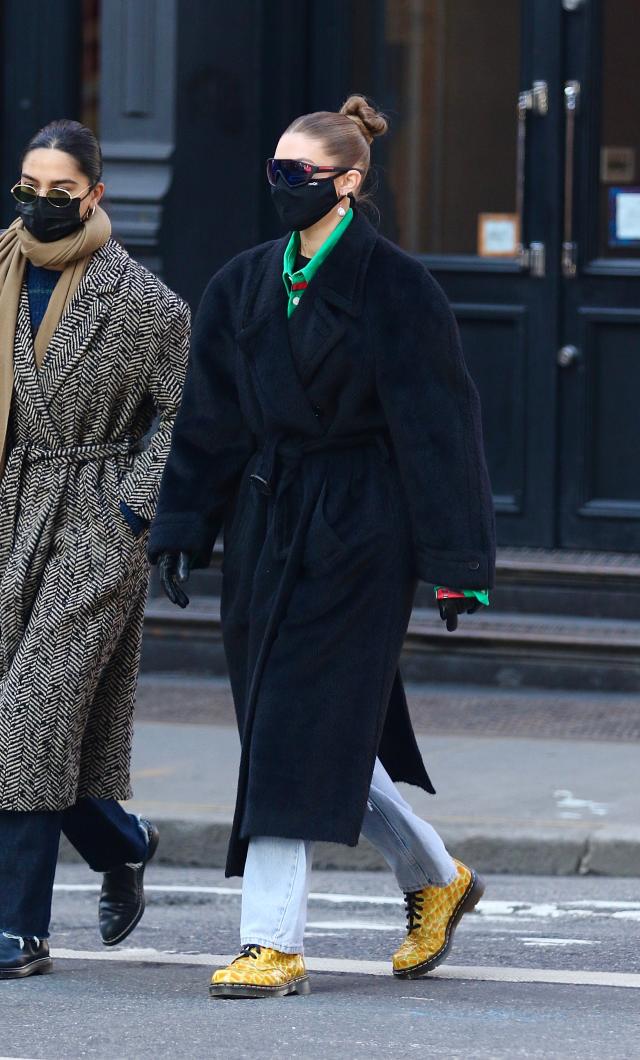 A guest wears a brown hat, a grey Louis Vuitton scarf, a grey jacket  News Photo - Getty Images