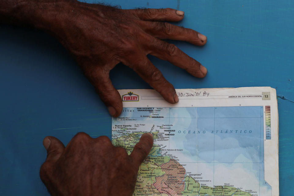 A local resident points at an area nicknamed the Dragon's Mouths, where Maroly Bastardo disappeared in the Caribbean Sea, in Guiria, Venezuela, on May 23. (Photo: Ivan Alvarado/Reuters)