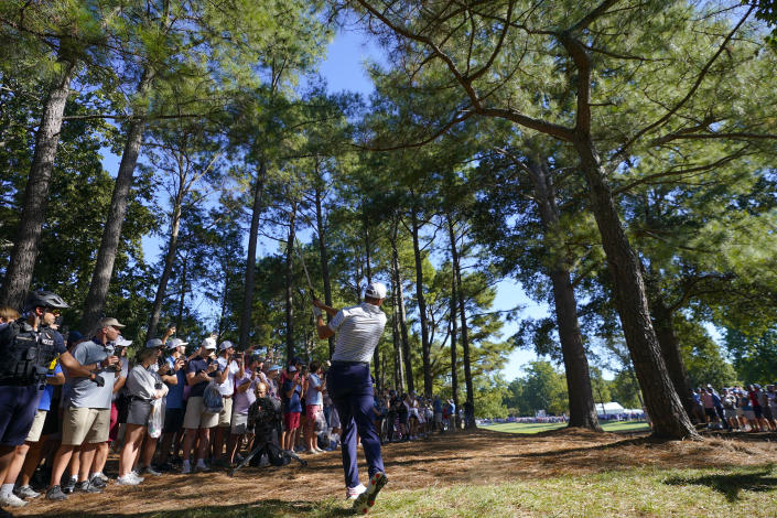 Jordan Spieth hits from the rough on the 16th hole during their fourball match at the Presidents Cup golf tournament at the Quail Hollow Club, Friday, Sept. 23, 2022, in Charlotte, N.C. (AP Photo/Julio Cortez)