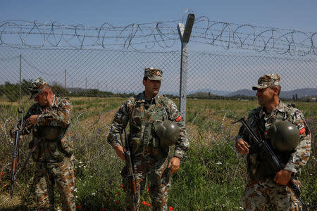 Macedonian soldiers patrol at the Macedonia-Greece border near Gevgelija, Macedonia, June 3, 2018. REUTERS/Marko Djurica