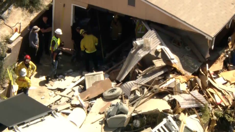 Investigators search the home of Michael Royce Spark on Friday, August 30. - KCAL/KCBS