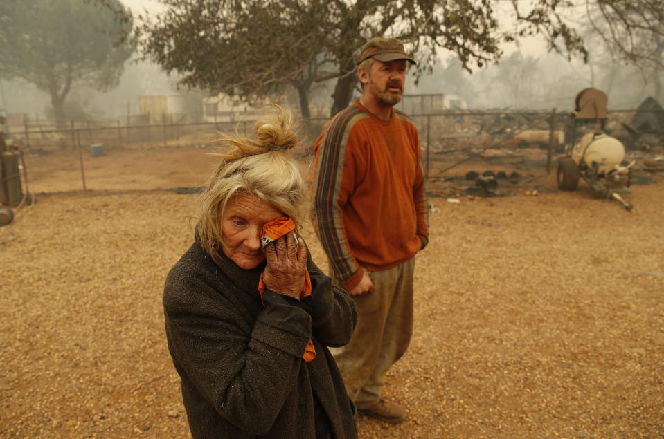 <p>Cathy Fallon wipes her face beside her son Gabriel Fallon as she stands near the charred remains of her home Friday, Nov. 9, 2018, in Paradise, Calif.<br>“I’ll be darned if I’m gonna let those horses burn in the fire” said Fallon, who stayed on her property to protect her 14 horses, “It has to be true love.”<br>All of the horses survived.<br>(Photo from John Locher, AP) </p>