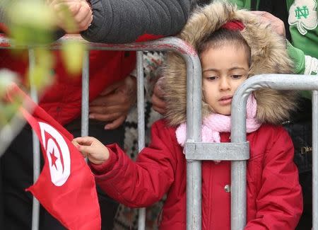 A girl waves a Tunisian flag during celebrations marking the sixth anniversary of Tunisia's 2011 revolution in Habib Bourguiba Avenue in Tunis, Tunisia January 14, 2017. REUTERS/Zoubeir Souissi