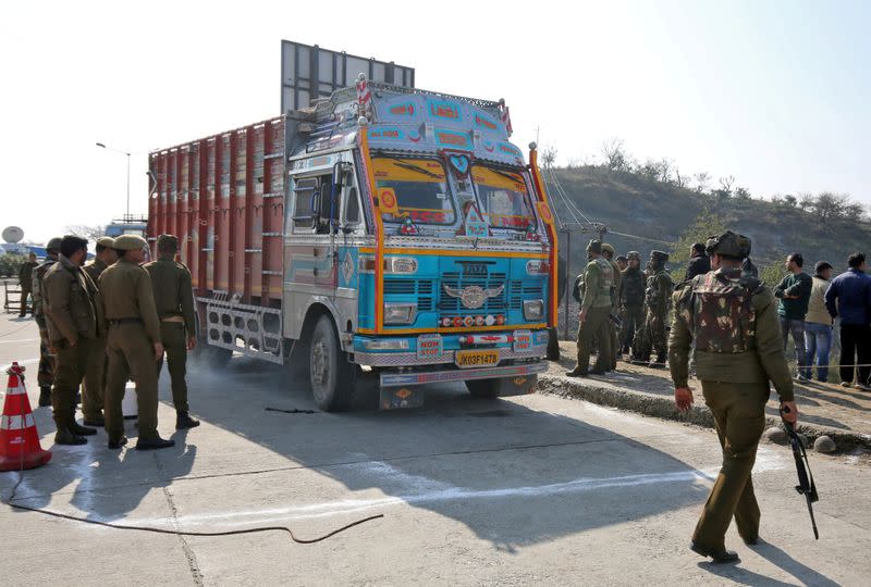 FILE PHOTO: Indian security forces stand around a truck which was used by suspected militants, at the site of a gun battle at Nagrota, on the outskirts of Jammu