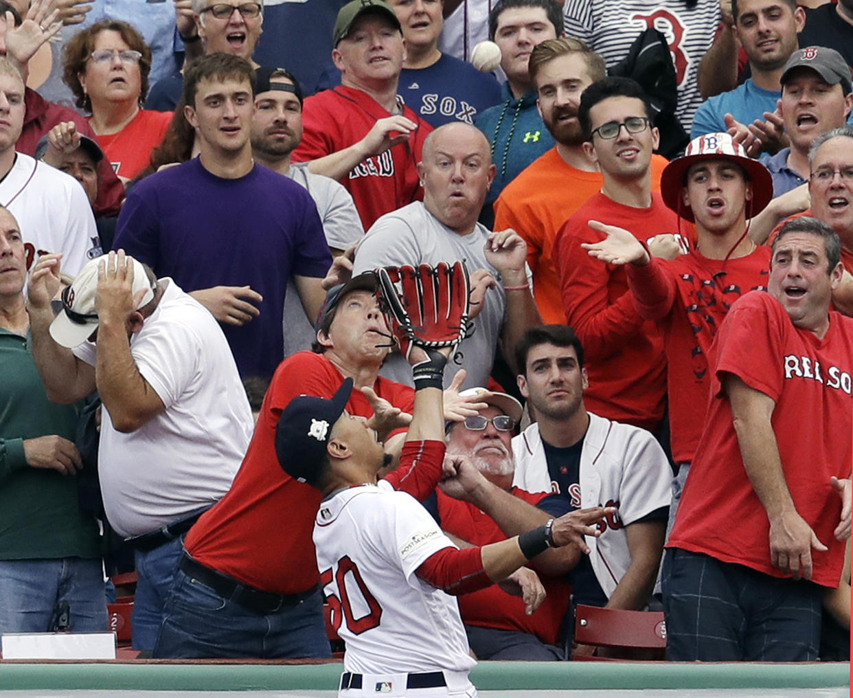 Red Sox right fielder Mookie Betts goes to the wall to catch a fly ball by Houston Astros' Josh Reddick during Game 3 of the ALDS. (AP)