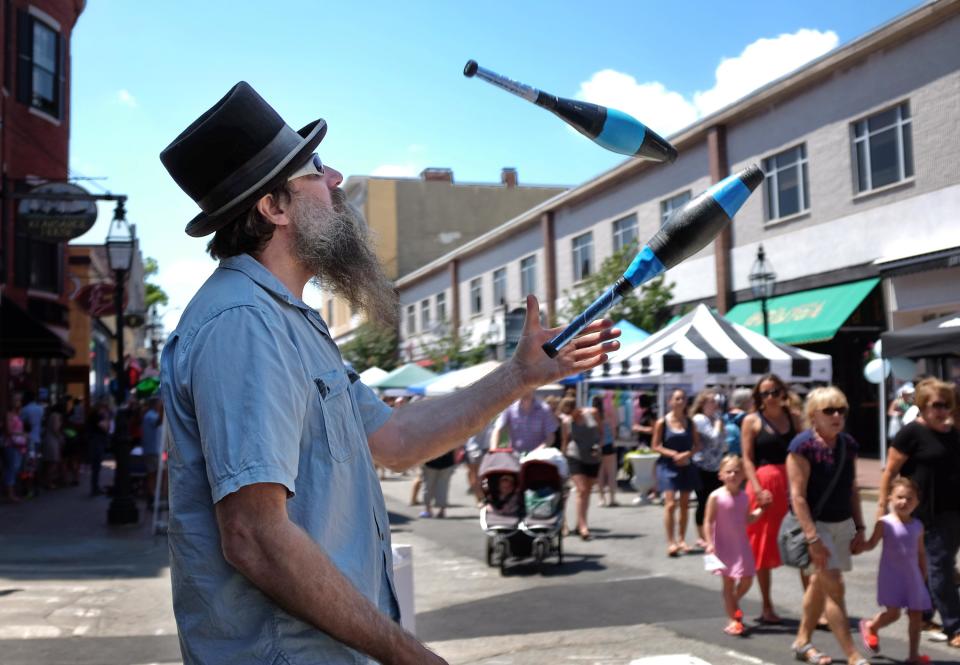 Pete Spofford juggles at the corner of Congress and Chestnut streets during Pro Portsmouth's 40th annual Market Square Day.