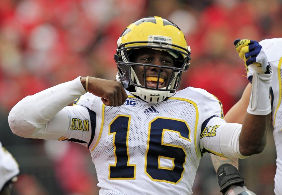 Michigan quarterback Denard Robinson celebrates his 67-yard touchdown run against Ohio State in the second quarter of an NCAA college football game Saturday, Nov. 24, 2012, in Columbus, Ohio.