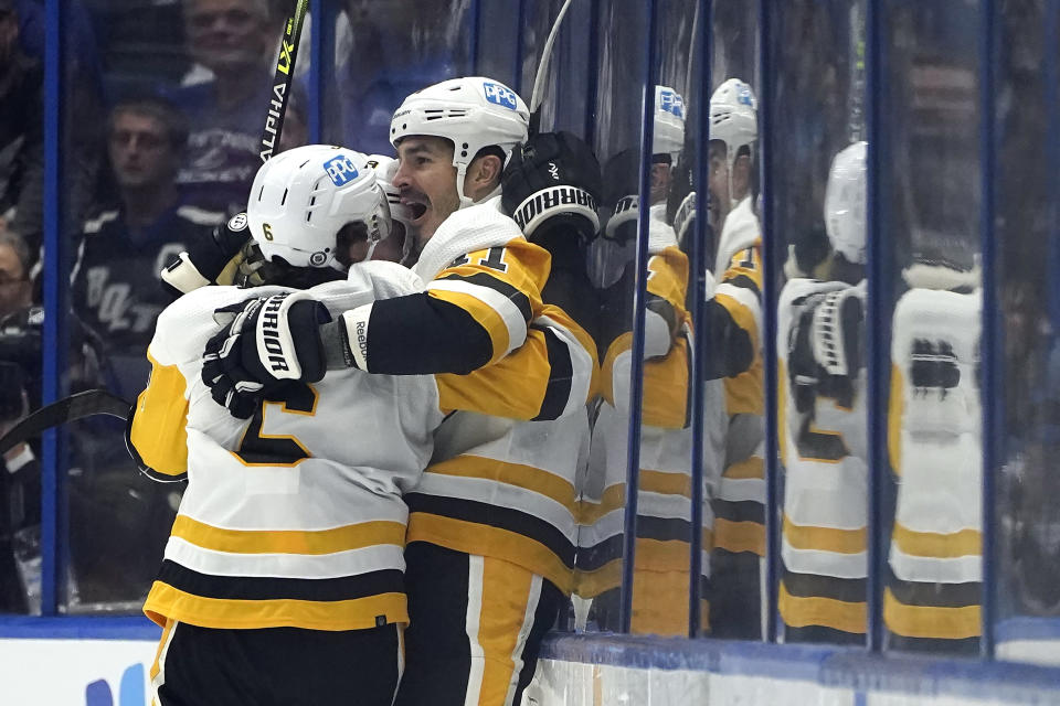 Pittsburgh Penguins center Brian Boyle (11) celebrates his goal against the Tampa Bay Lightning with defenseman John Marino (6) during the second period of an NHL hockey game Tuesday, Oct. 12, 2021, in Tampa, Fla. (AP Photo/Chris O'Meara)