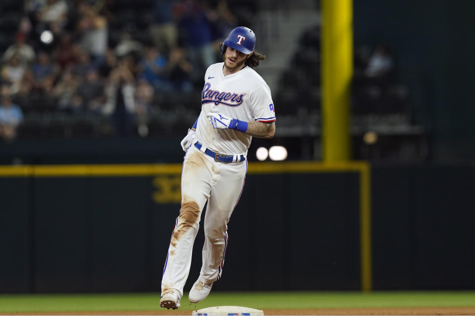 Texas Rangers Jonah Heim rounds the bases after hitting a solo home run during the seventh inning of a baseball game against the Los Angeles Angels in Arlington, Texas, Monday, May 16, 2022. The Rangers won 7-4. (AP Photo/LM Otero)