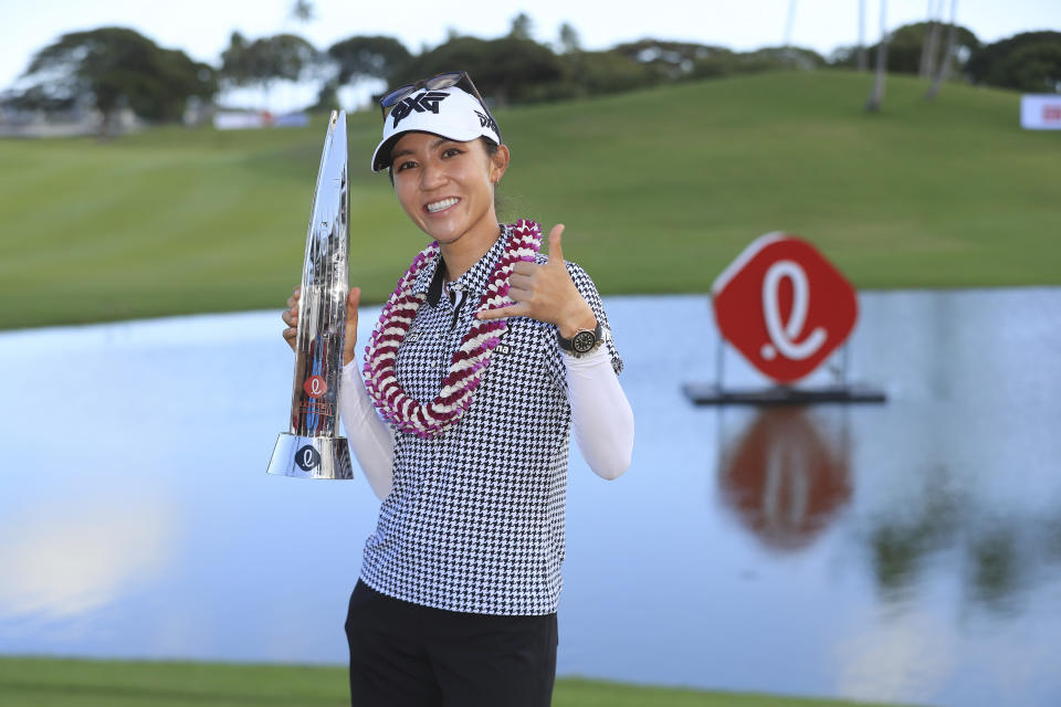 Lydia Ko, of New Zealand, holds the Lotte Championship trophy after winning the golf tournament, Saturday, April 17, 2021, in Kapolei, Hawaii. (AP Photo/Marco Garcia)