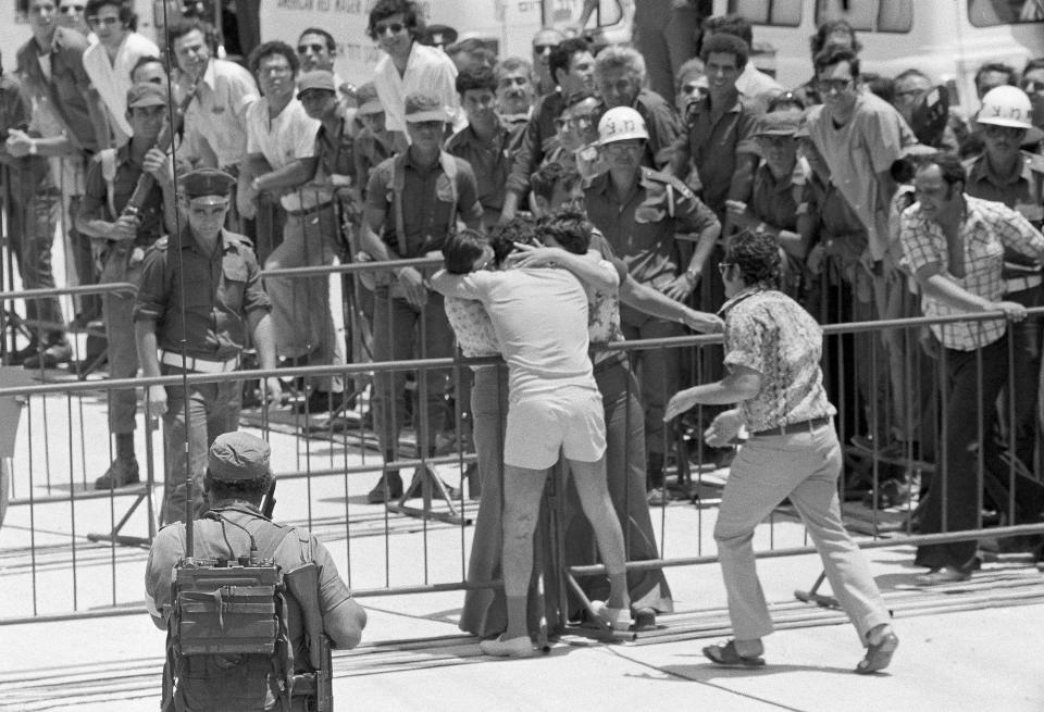 FILE - In this June 1, 1974, file photo taken by Max Nash, Israeli POW who returned to Tel Aviv's Ben-Gurion Airport is given an emotional greeting by family members. Nash, who covered the conflicts in Southeast Asia and the Middle East and helped nurture a new generation of female photojournalists during more than 40 years with The Associated Press, died Friday, Sept. 28, 2018, after collapsing at home. He was 77. (AP Photo/Max Nash, File)