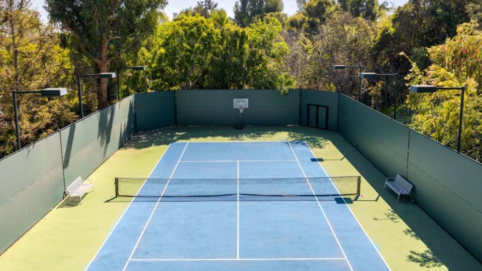 This Holmby Hills estate has a dual tennis and basketball court tucked behind the home. - Credit: Beverly Hills Estates