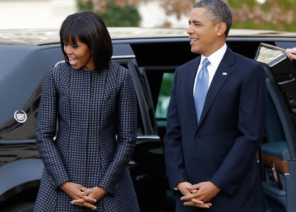 President Barack Obama and first lady Michelle Obama react as they watch their daughters as the first family arrives at St. John's Church in Washington, Monday, Jan. 21, 2013, for a church service during the 57th Presidential Inauguration. (AP Photo/Jacquelyn Martin)