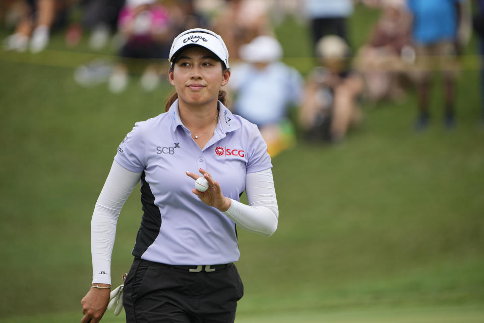 Atthaya Thitikul of Thailand reacts after she played at the18th hole during the third round of the LPGA Maybank Championship in Kuala Lumpur, Malaysia, Saturday, Oct. 28, 2023. (AP Photo/Vincent Thian)