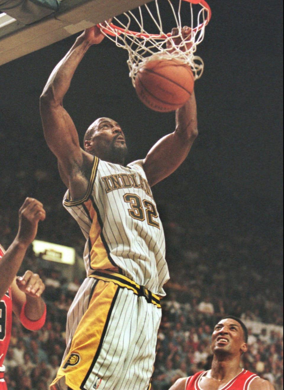 Indiana Pacers' Dale Davis slams home two points as Chicago Bulls' Scottie Pippen, right, watches during the third quarter of Game 6 of the Eastern Conference finals Friday, May 29, 1998 in Indianapolis.