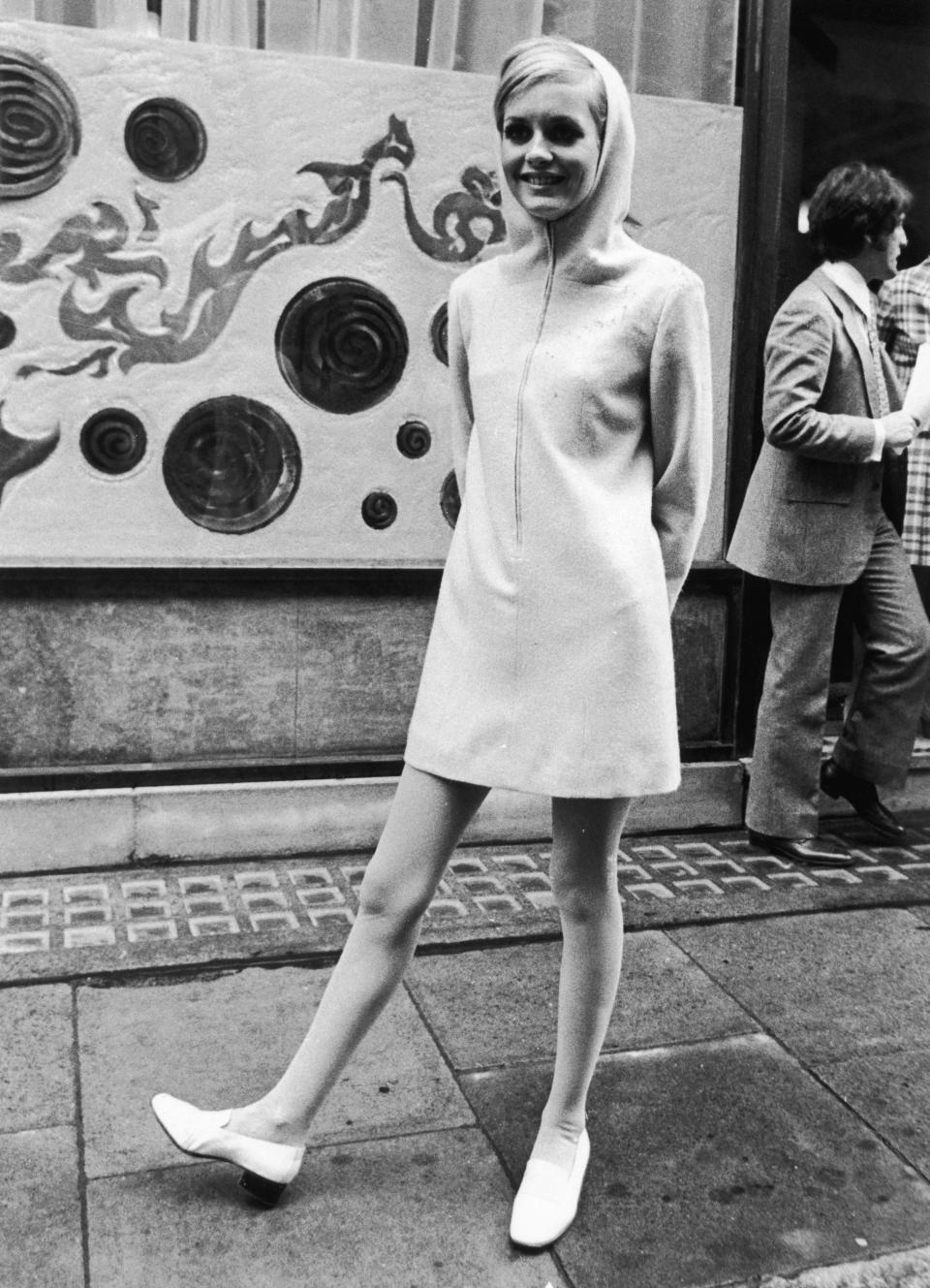 Twiggy, then 17, wears a hooded minidress in London.