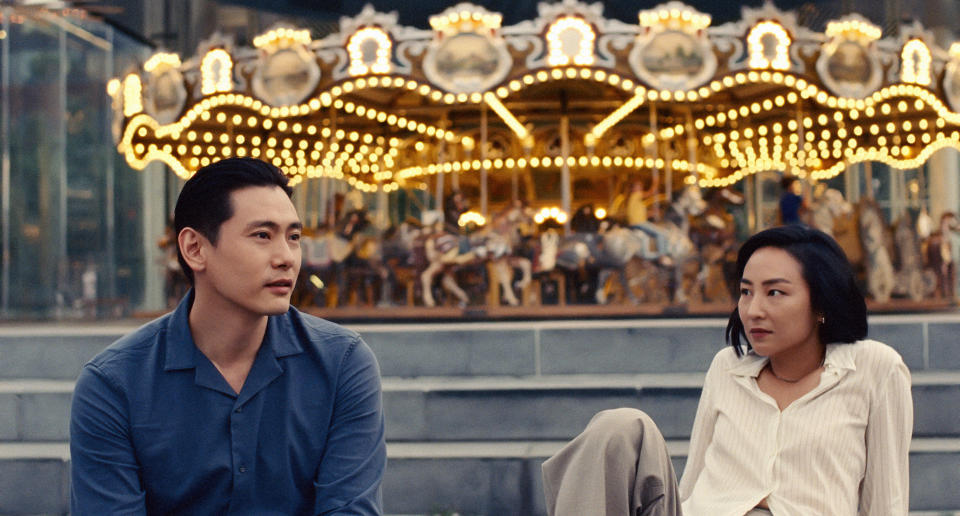 This image released by A24 shows Greta Lee, right, and Teo Yoo in a scene from "Past Lives." (Jon Pack/A24 via AP)