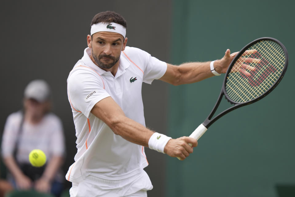 Bulgaria's Grigor Dimitrov plays a return to Frances Tiafoe of the US during the men's singles match on day seven of the Wimbledon tennis championships in London, Sunday, July 9, 2023. (AP Photo/Alberto Pezzali)