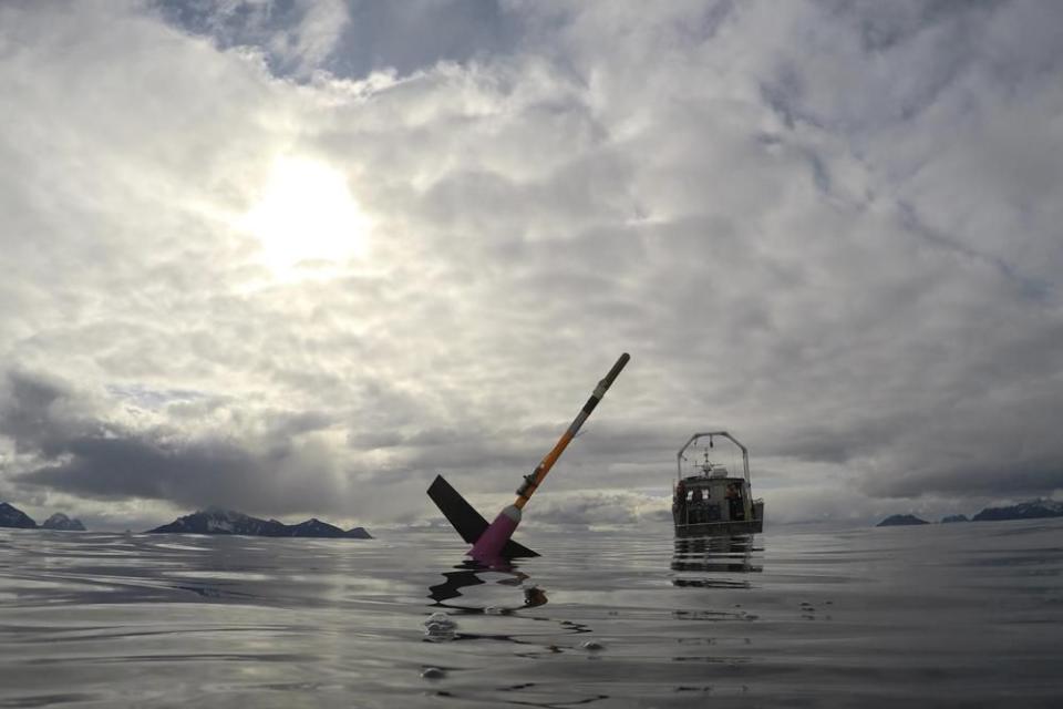 This April 28, 2022, photo provided by Andrew McDonnell shows an underwater glider waiting to be picked up in the Gulf of Alaska by the University of Alaska Fairbanks research vessel Nanuq. The glider was fitted with a special sensor that will collect an enormous amount of data to study ocean acidification. (Andrew McDonnell via AP)